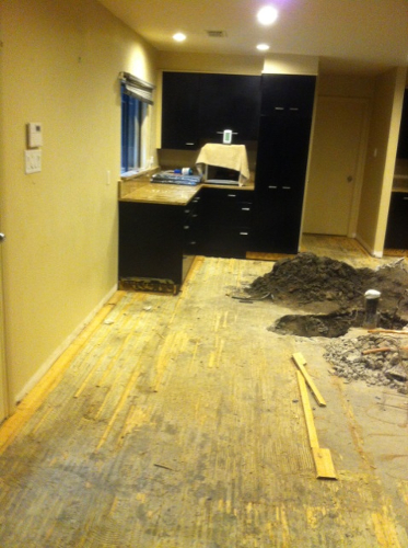 kitchen with a slab leak before repair and restoration
